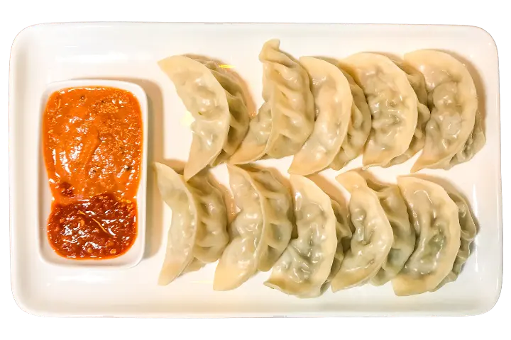 Freshly steamed Nepali momos with tomato achar